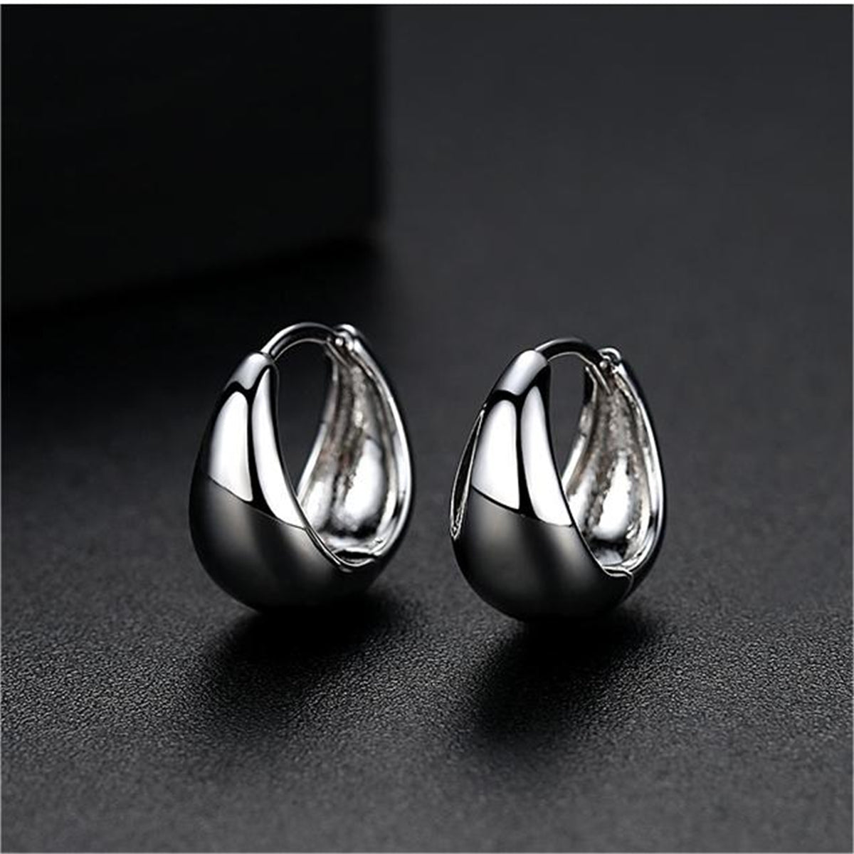 Silver-Plated Oval Huggie Earrings, silver huggie earrings, dainty minimalist design, detail close-up