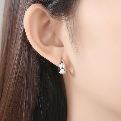 Silver-Plated Oval Huggie Earrings, silver huggie earrings, dainty minimalist design, front view