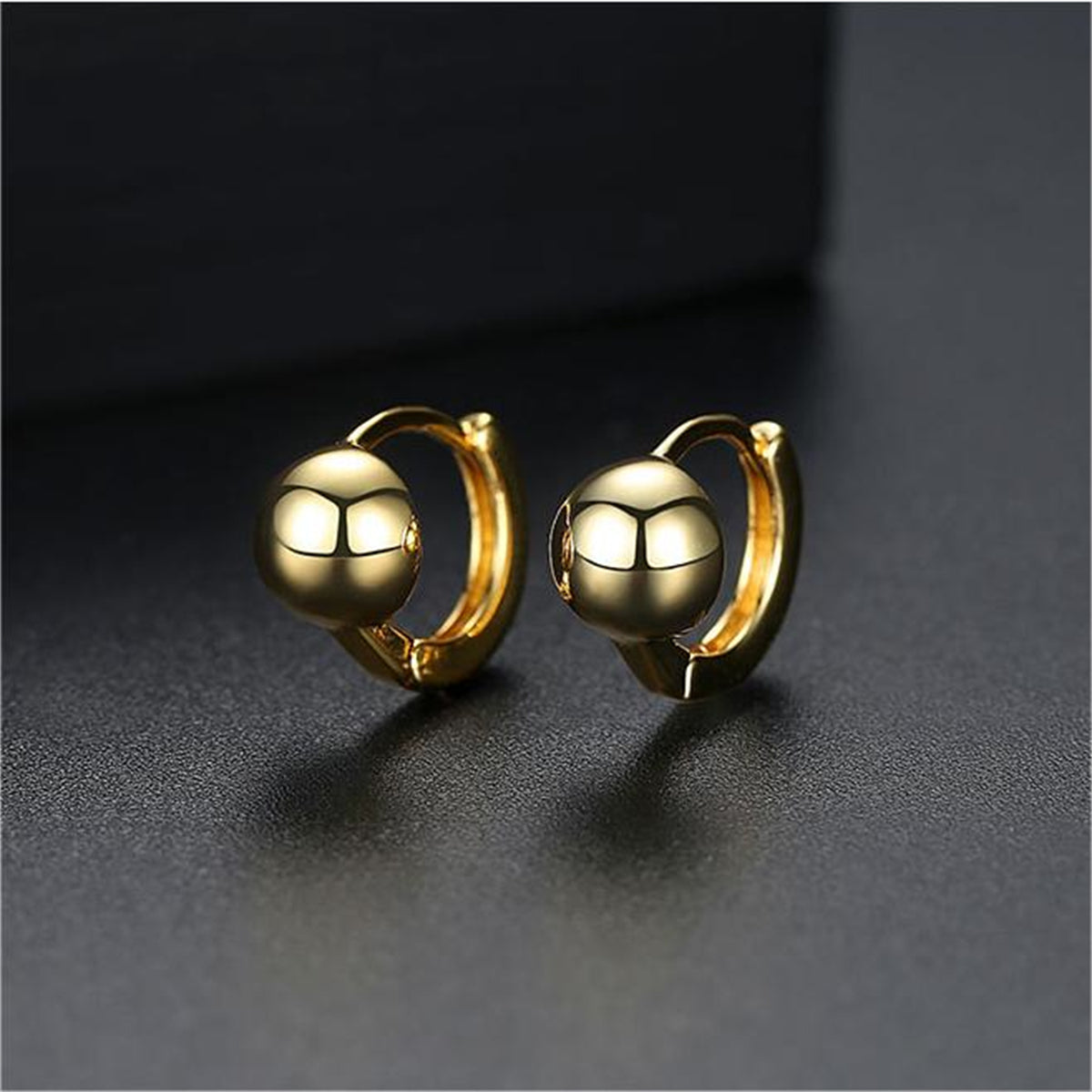 Stylish 18K gold-plated ball earrings, perfect for adding a touch of elegance to any outfit with their radiant gold tone.