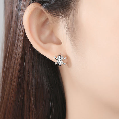 Cubic Zirconia and Silver-Plated Skull Huggie Earrings, silver huggie earrings, everyday style, detail close-up