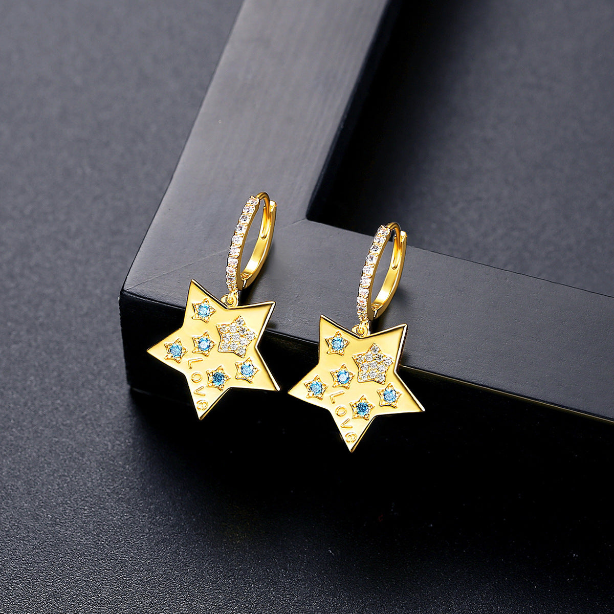 Blue Cubic Zirconia and 18K Gold-Plated Star Huggie Earrings, gold huggie earrings, vintage-inspired design, front view