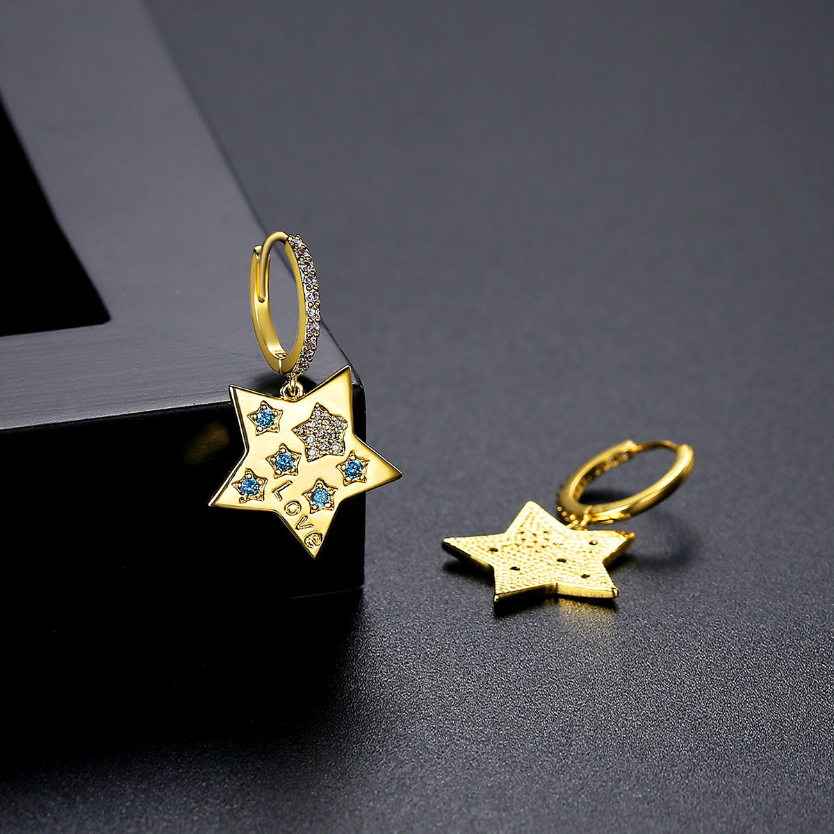 Blue Cubic Zirconia and 18K Gold-Plated Star Huggie Earrings, gold huggie earrings, vintage-inspired design, detail close-up