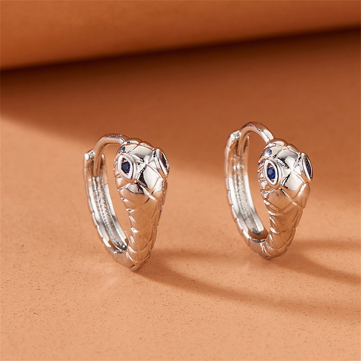 Blue Cubic Zirconia and Silver-Plated Snake Huggie Earrings, silver huggie earrings, dainty minimalist design, side view