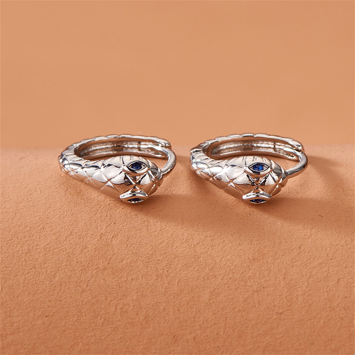 Blue Cubic Zirconia and Silver-Plated Snake Huggie Earrings, silver huggie earrings, detail close-up