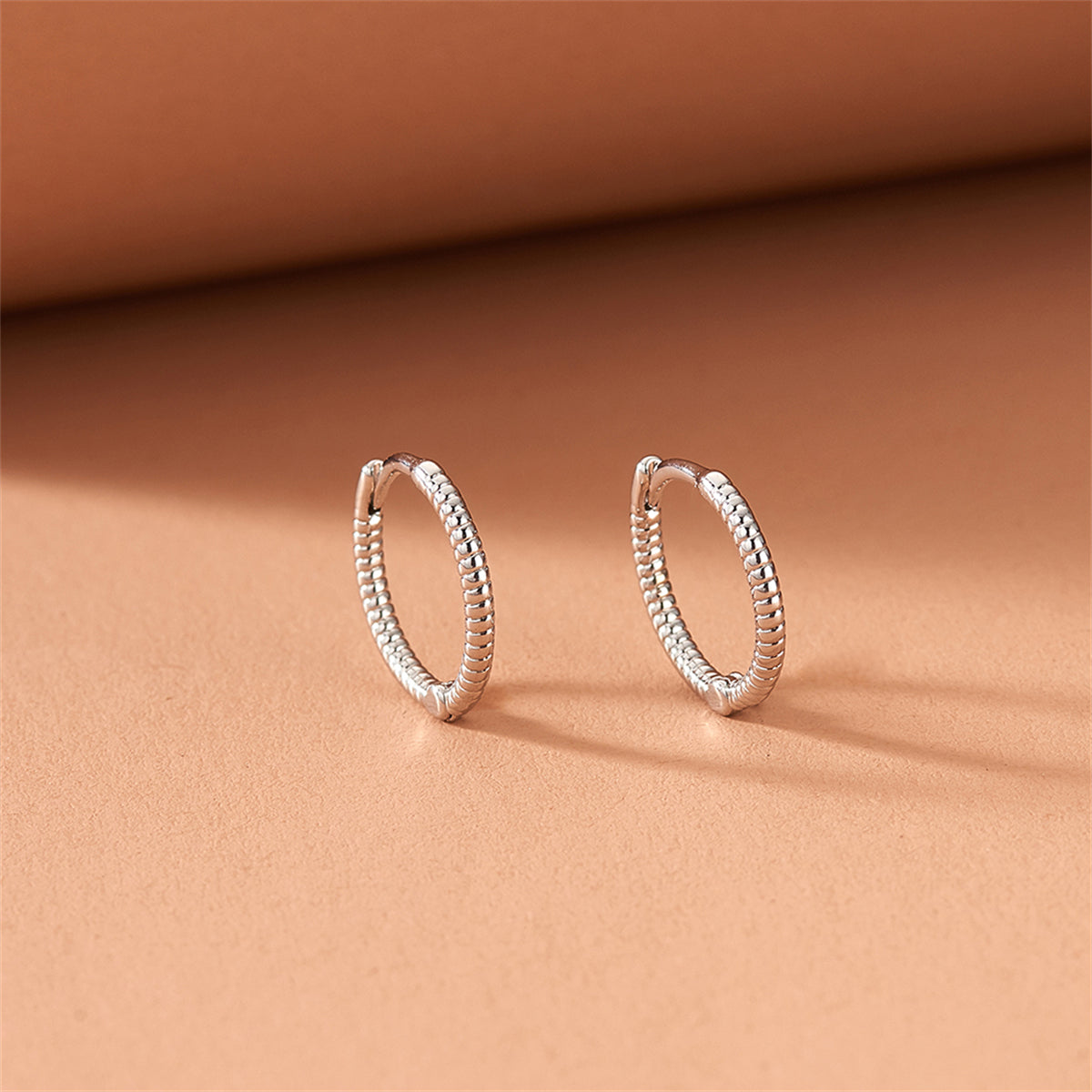 Silver-Plated Twine Huggie Earrings, silver huggie earrings, vintage-inspired design, side view