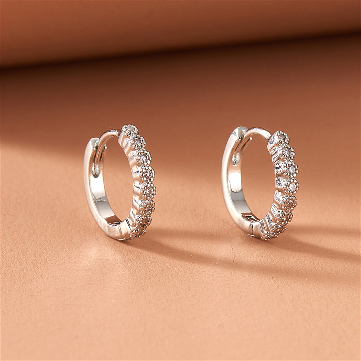 Cubic Zirconia and Silver-Plated Bezel Huggie Earrings, silver huggie earrings, everyday style, side view
