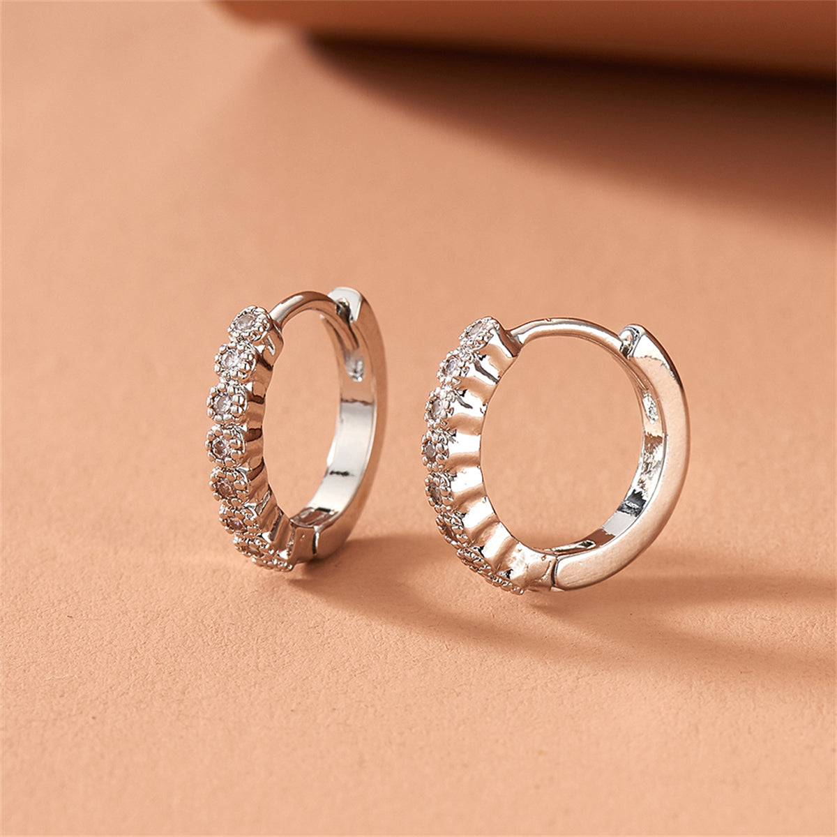Cubic Zirconia and Silver-Plated Bezel Huggie Earrings, silver huggie earrings, everyday style, detail close-up