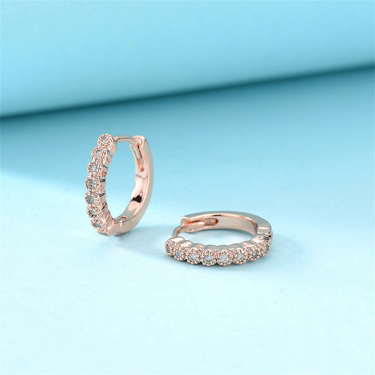Cubic Zirconia and 18K Rose Gold-Plated Bezel Huggie Earrings, rose gold huggie earrings, everyday style, detail close-up