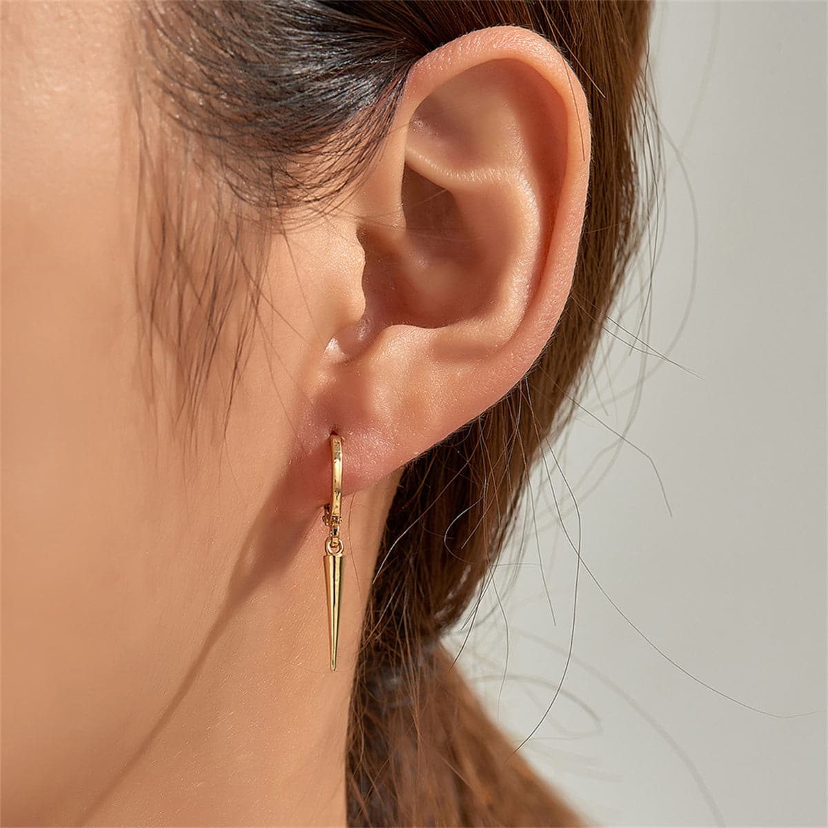 Trendy 18K gold-plated huggie earrings with a sharp spike design, ideal for those who love to stand out.