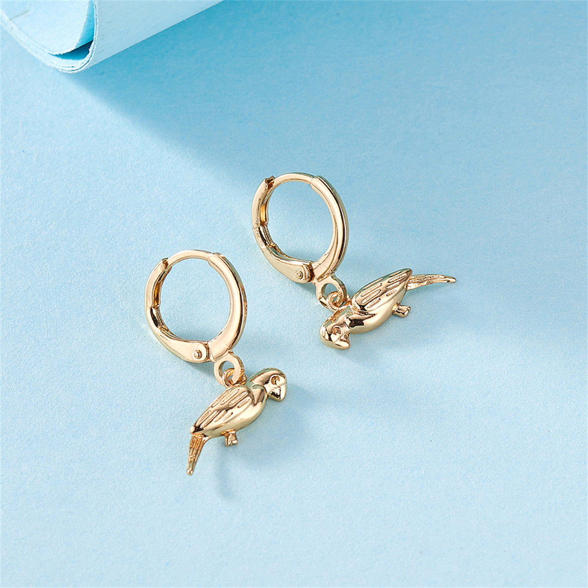 Beautifully crafted 18K gold-plated parrot huggie earrings, a chic accessory for any fashion-forward individual.