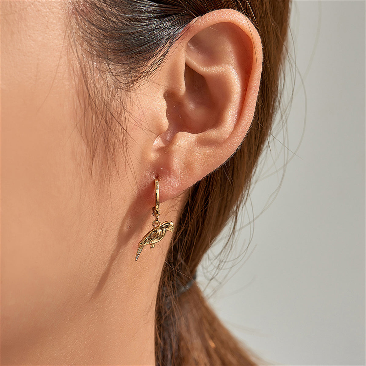 Dazzling 18K gold-plated parrot huggie earrings, a stylish choice for those who love unique and luxurious accessories.
