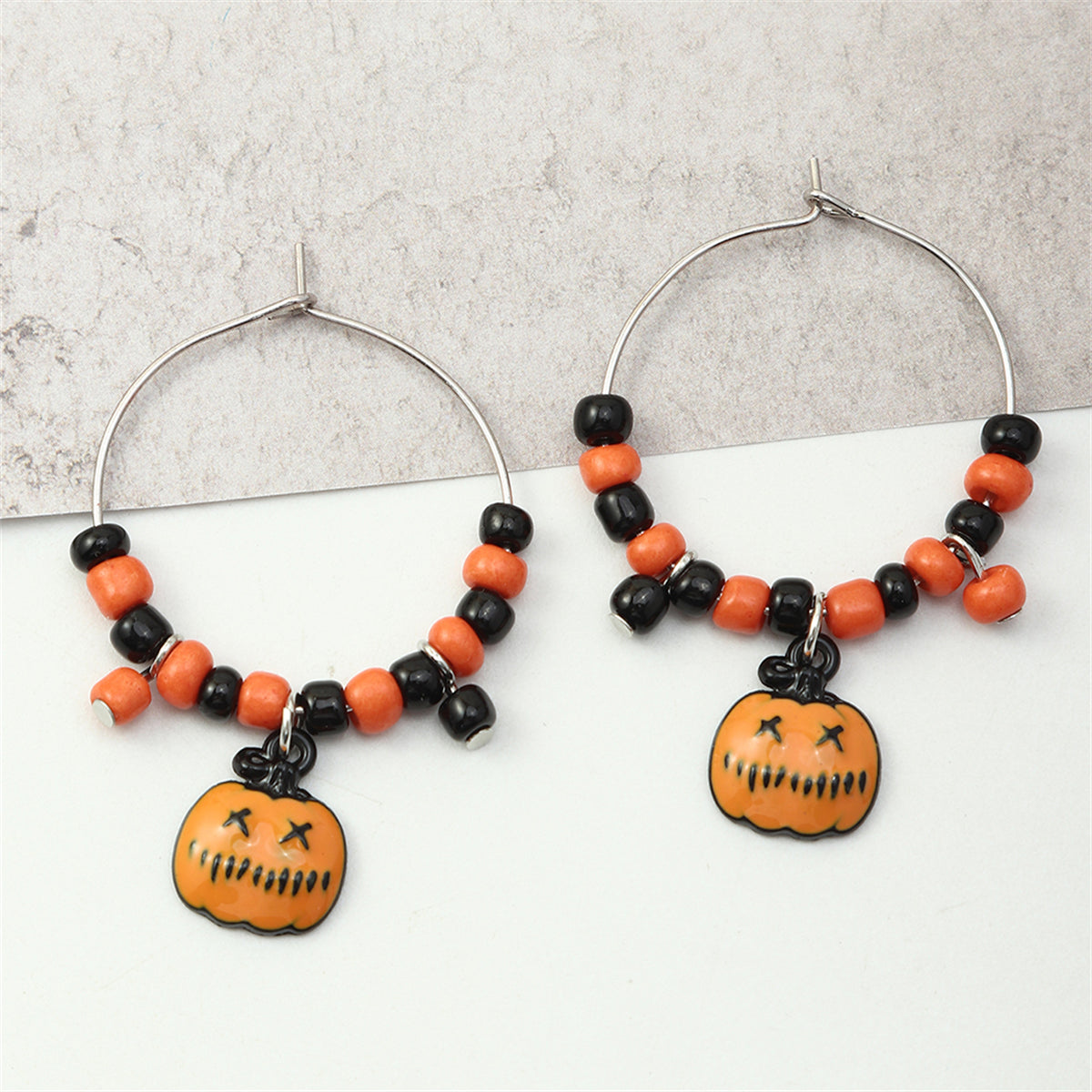 Orange Howlite and Silver-Plated Pumpkin Huggie Earrings, silver huggie earrings, vintage-inspired design, front view