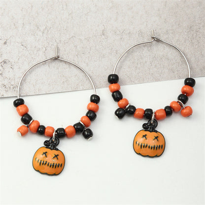 Orange Howlite and Silver-Plated Pumpkin Huggie Earrings, silver huggie earrings, vintage-inspired design, front view