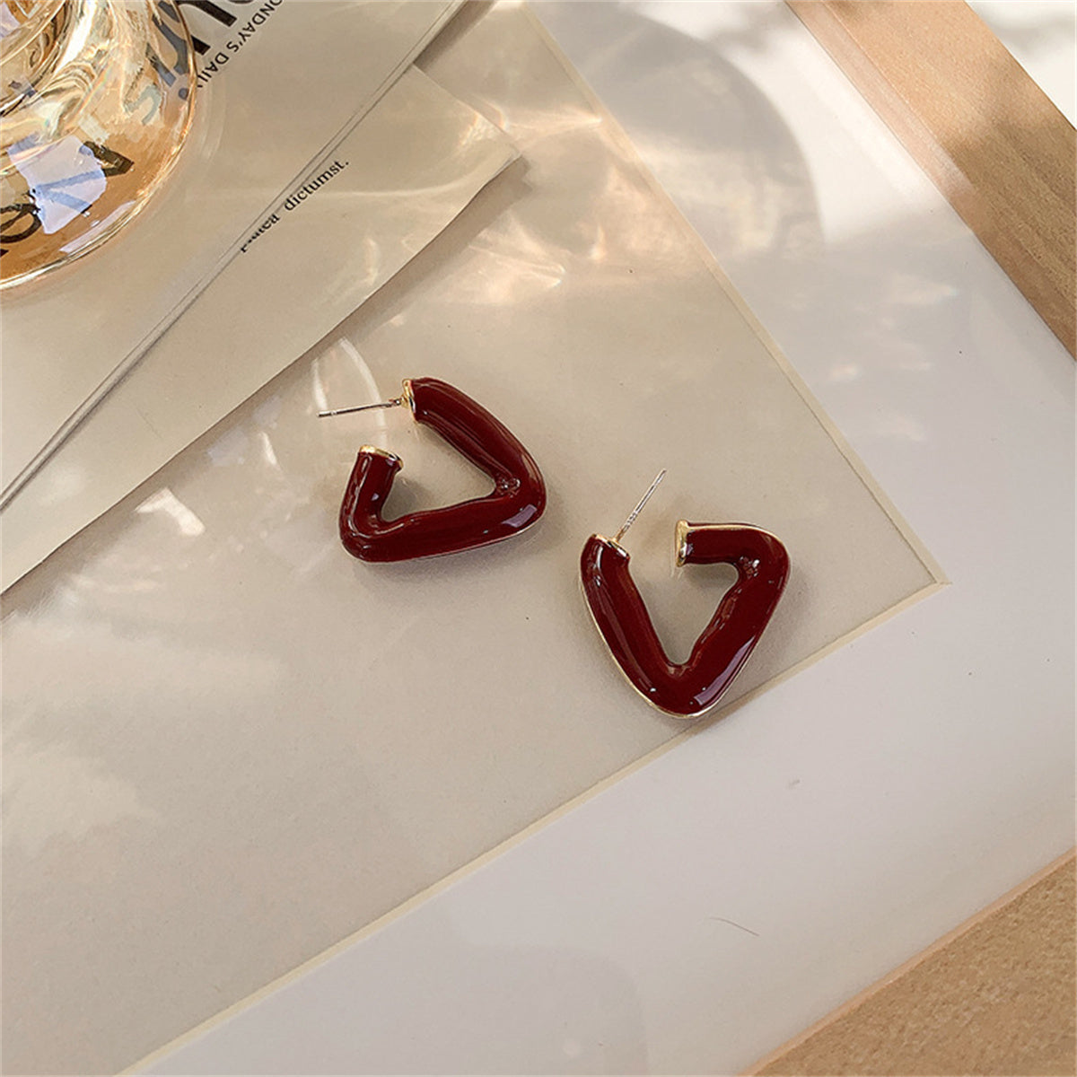 Red Enamel and 18K Gold-Plated Open Triangle Huggie Earrings, gold huggie earrings, dainty minimalist design, front view