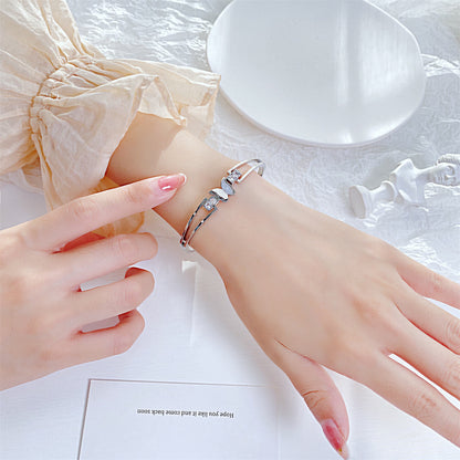 Cubic Zirconia and Silver-Plated Frosted Butterfly Layered Band Bangle, silver bangle bracelet, detail close-up