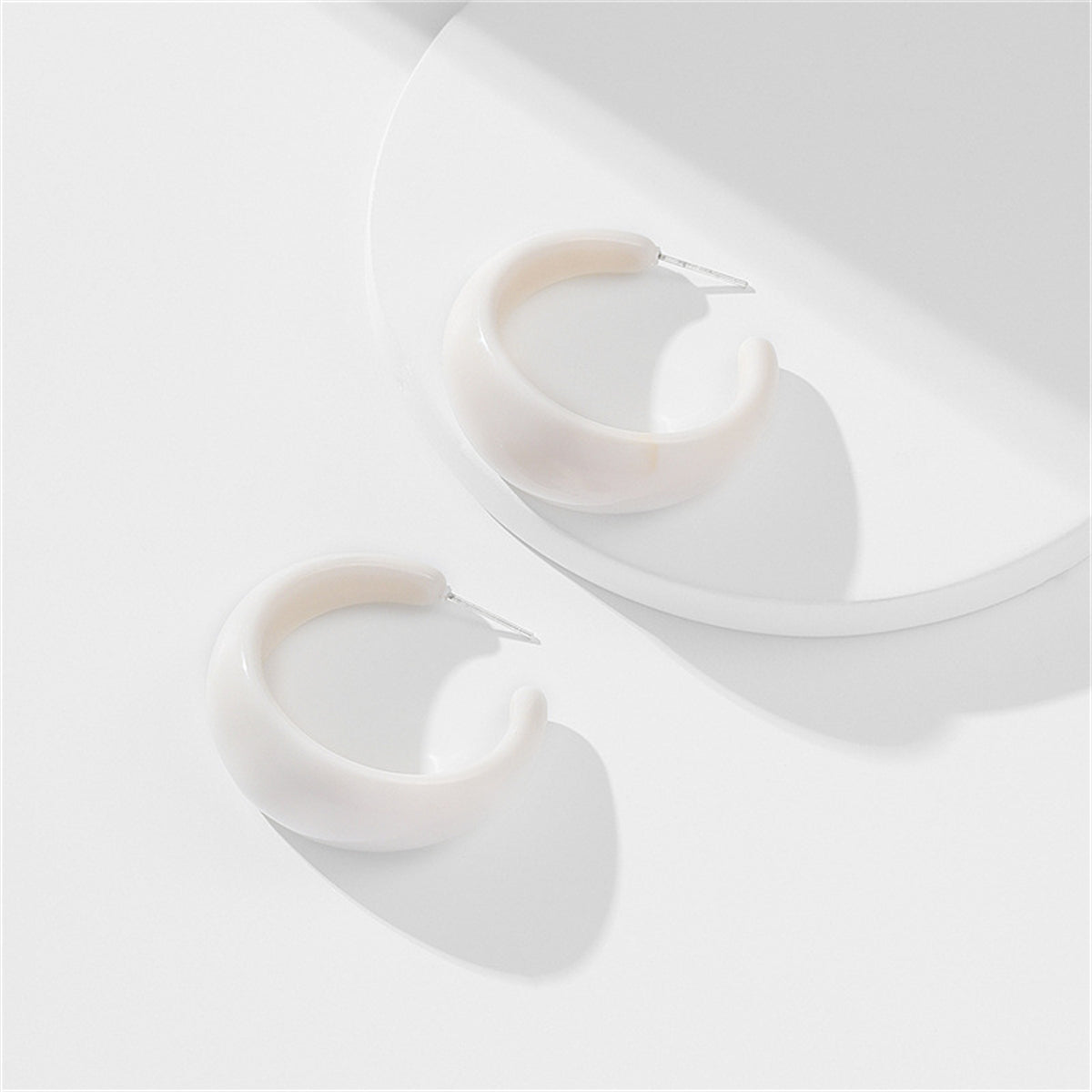 White Resin and Silver-Plated Huggie Earrings, silver huggie earrings, dainty minimalist design, front view