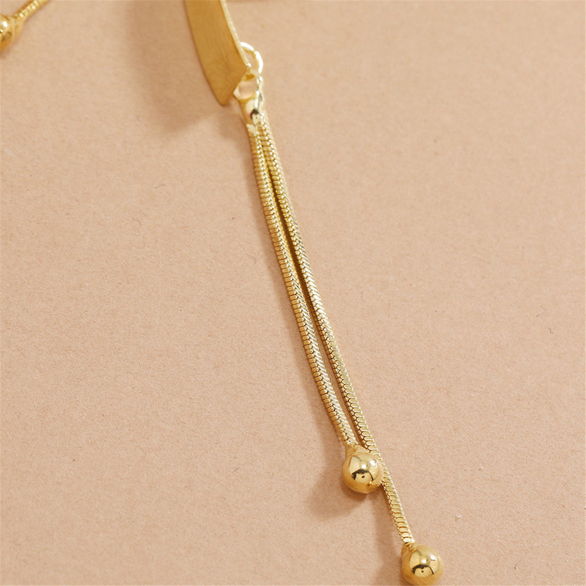 Beautiful 18K gold-plated earrings featuring a modern rectangular bar and two small balls, perfect for any fashionista.