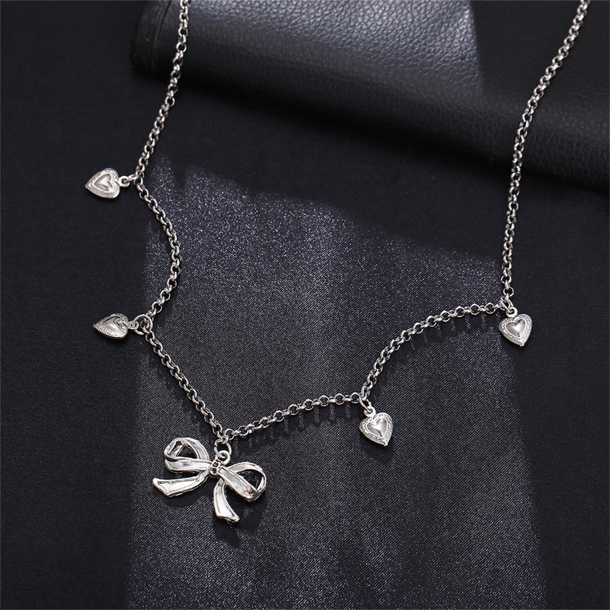 Silver-Plated Bow Heart Station Necklace, silver pendant necklace for women, elegant gift for her, front view
