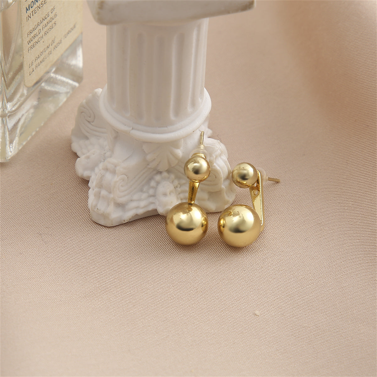 Dazzling 18K gold-plated ear jackets adorned with two exquisite balls, perfect for making a bold fashion statement.