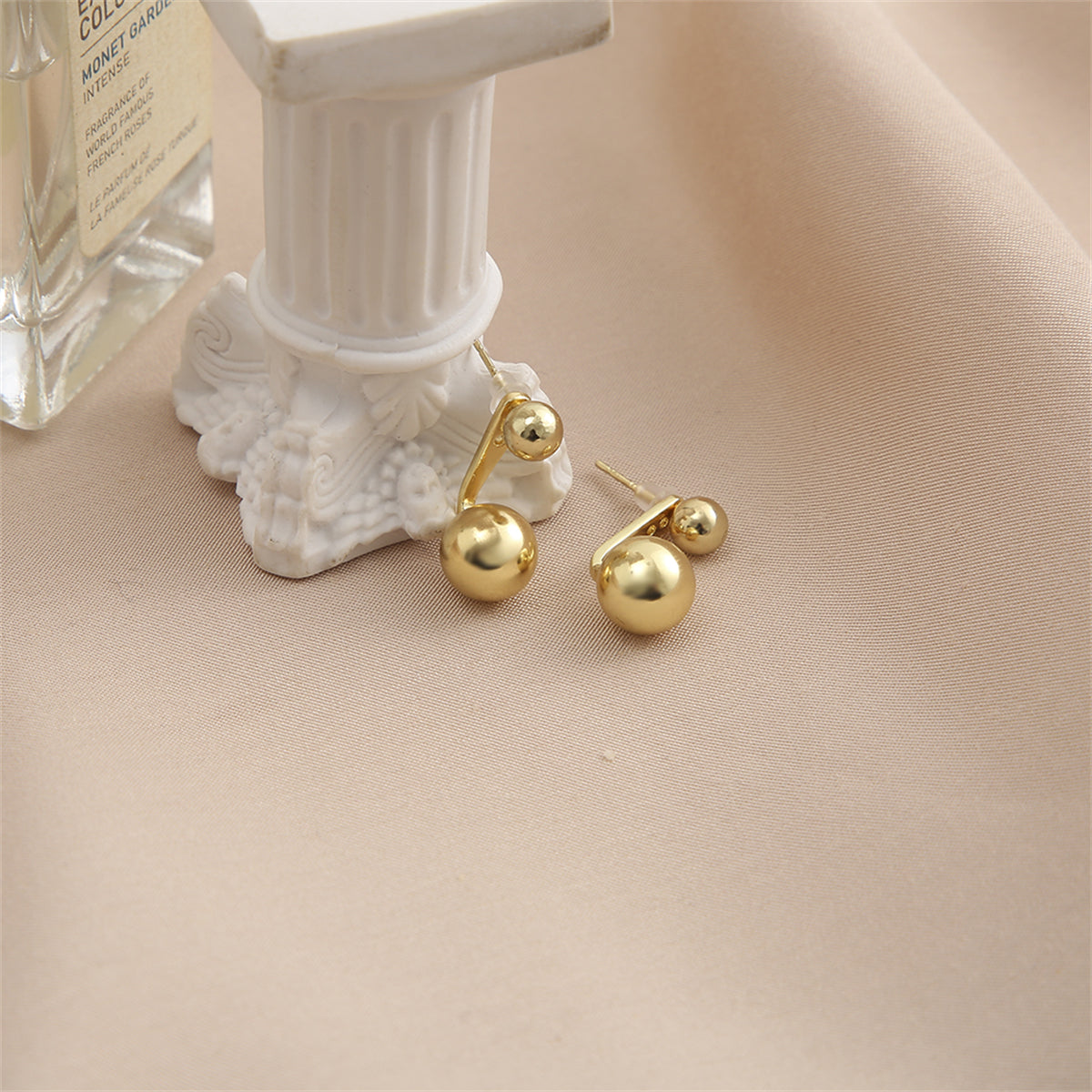 Sophisticated 18K gold-plated ball ear jackets featuring two elegant balls, enhancing your style with a touch of elegance.