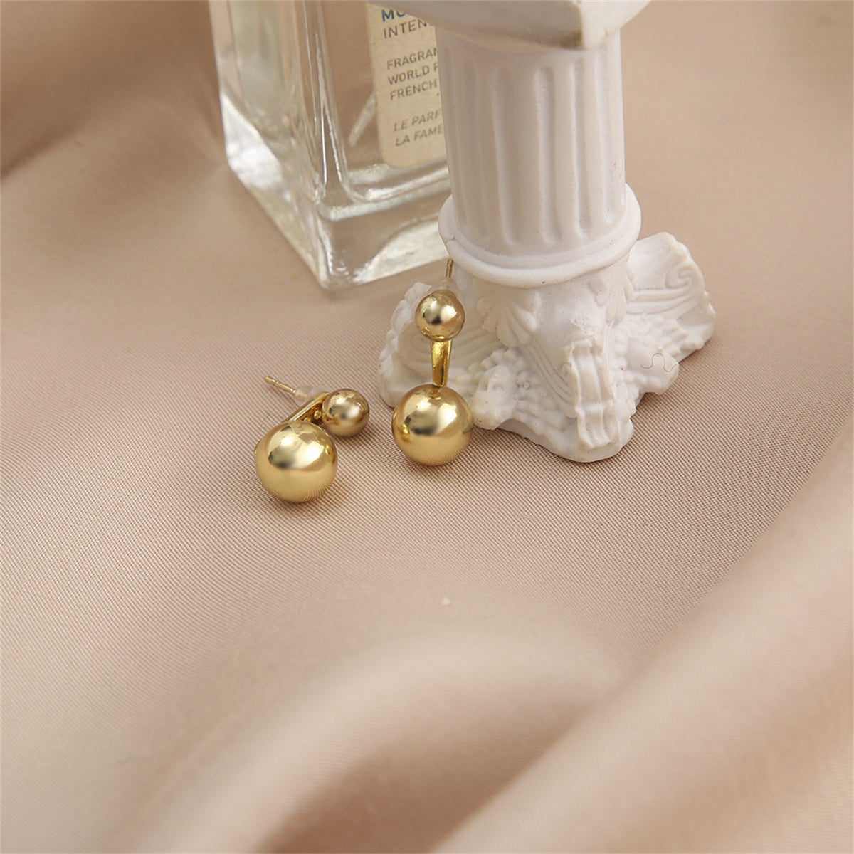 Stylish 18K gold-plated ear jackets with two eye-catching balls, a must-have accessory for a glamorous look.