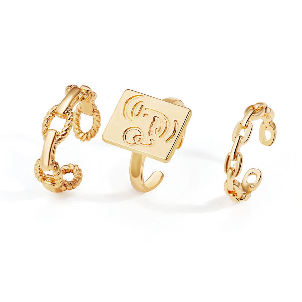 A chic set of three gold-plated rings featuring initials, complemented by a trendy chain for a unique accessory look.