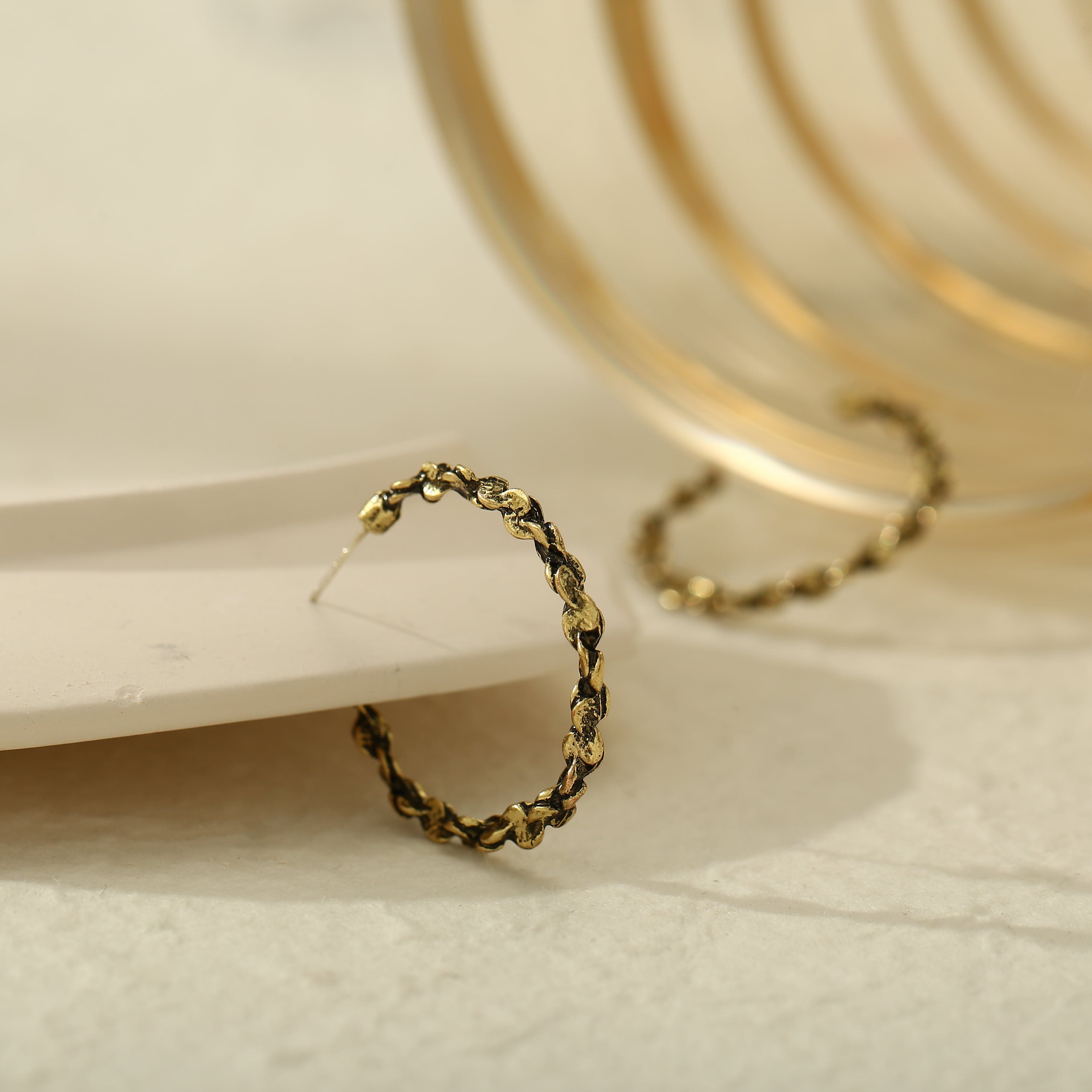 Eye-catching 18K gold-plated open hoop earrings with a textured finish and chain detail, perfect for any occasion.