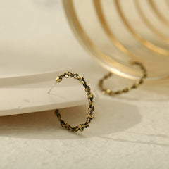 Eye-catching 18K gold-plated open hoop earrings with a textured finish and chain detail, perfect for any occasion.