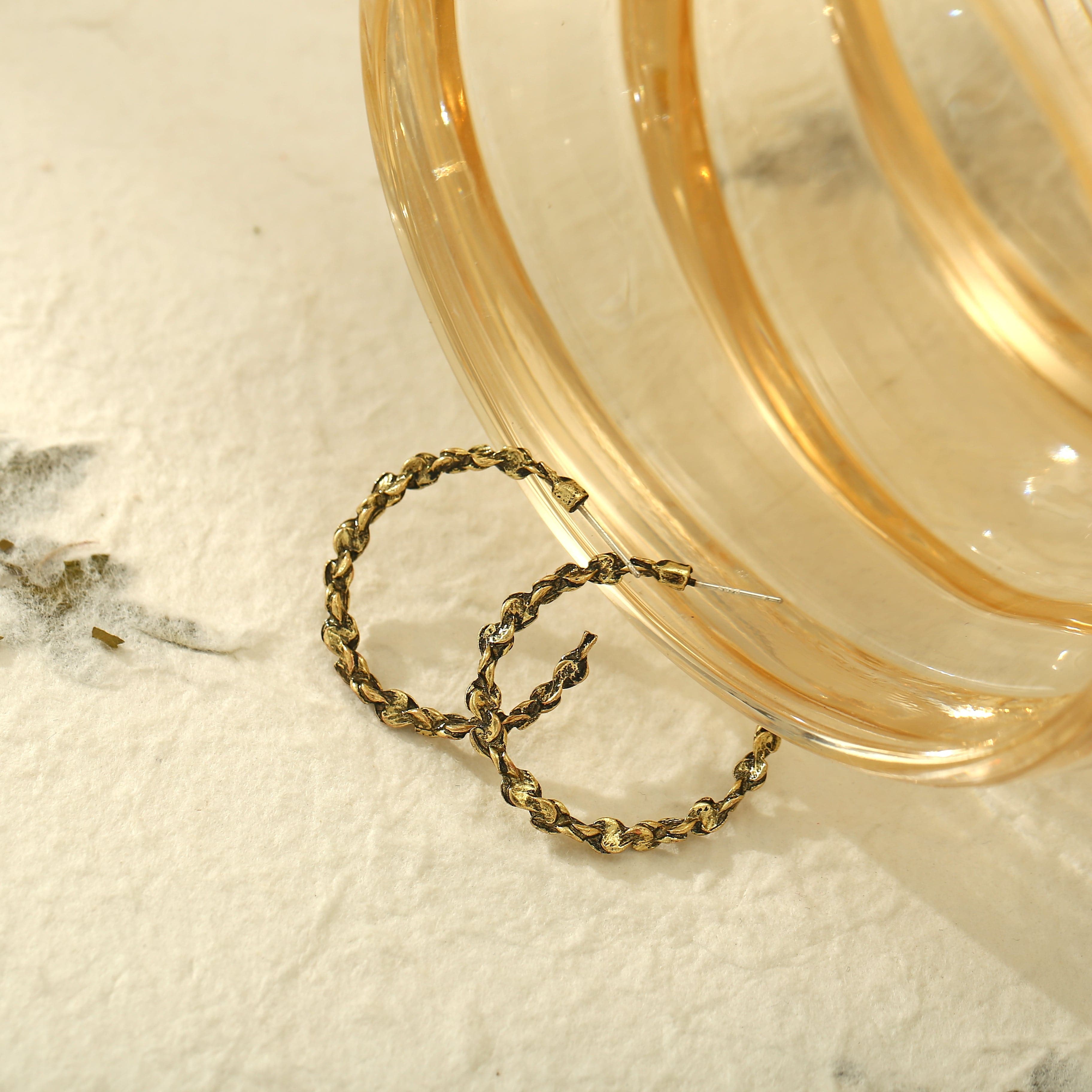 Trendy 18K gold-plated hoop earrings with an abstract design and chain, a stylish addition to enhance your ensemble.