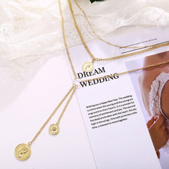 Gorgeous 18K gold-plated necklace with a coin charm, elegantly layered on a chain, adding sophistication to any outfit.