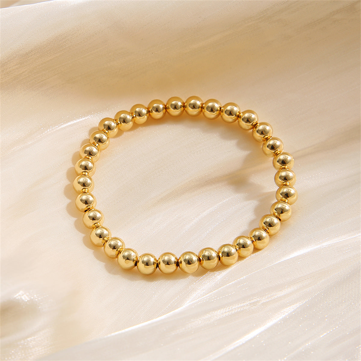 Chic 18K gold-plated bead bracelet made from a single strand of gleaming gold beads, ideal for stylish accessorizing.