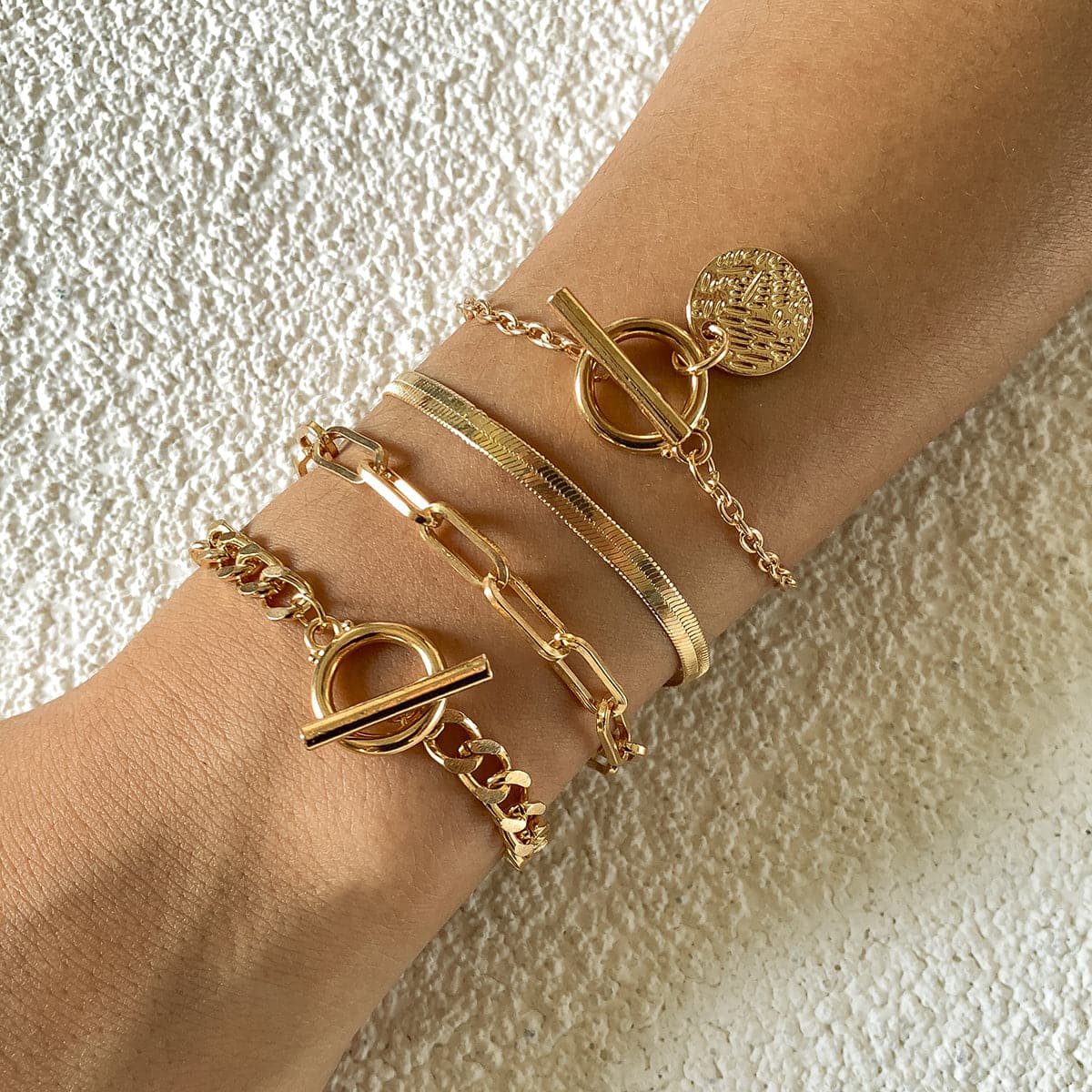 Three elegant 18K gold-plated bracelets featuring a chain and clasp, perfect for any stylish occasion.