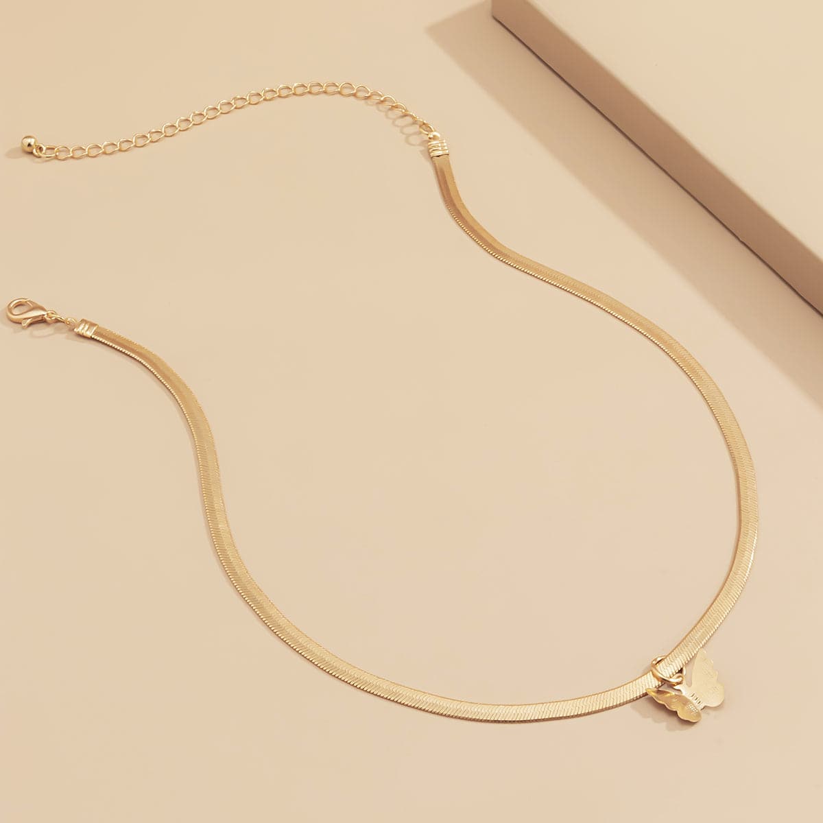 Dazzling 18K gold-plated butterfly choker necklace with a refined snake chain, a timeless piece for any jewelry collection.
