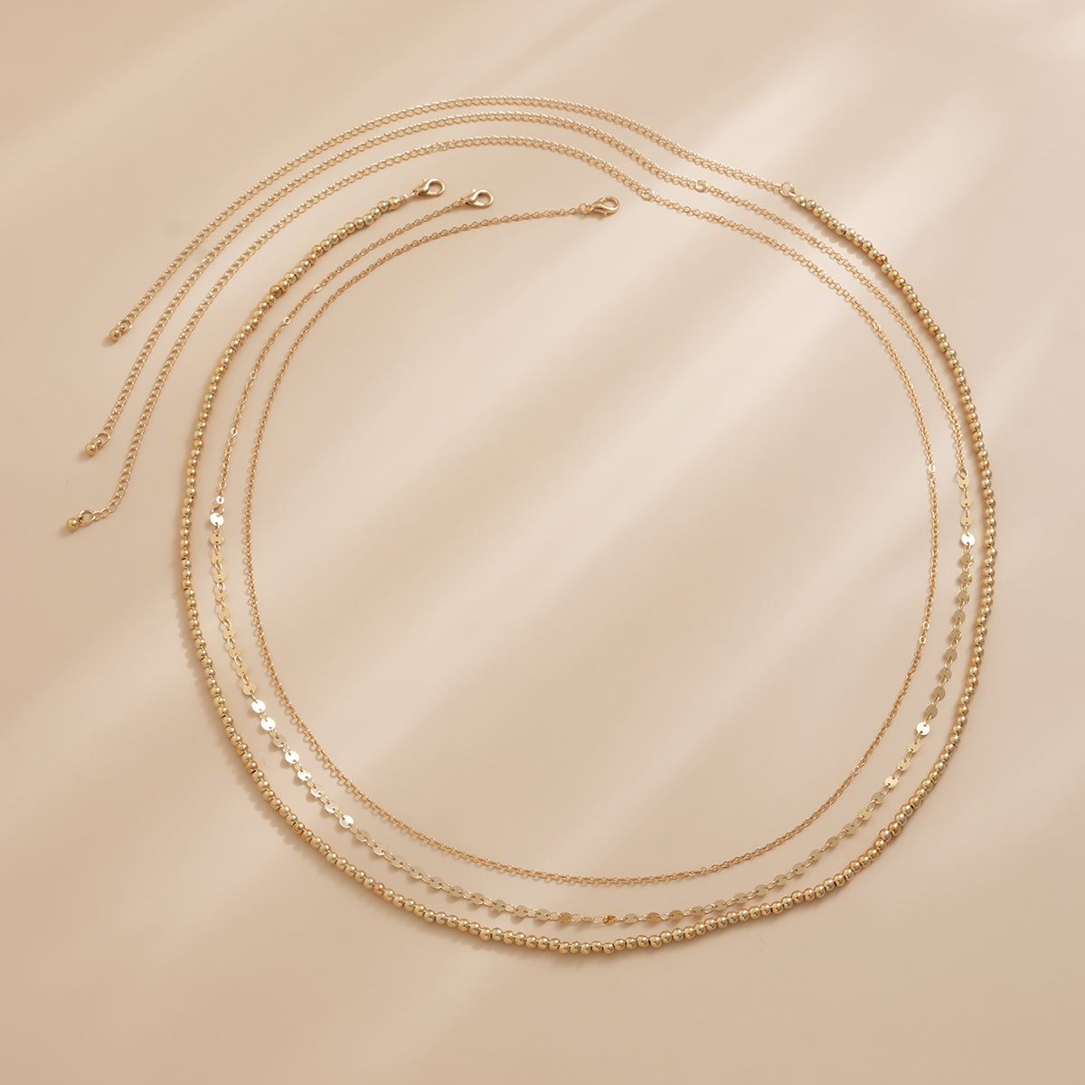 Beautiful 18K gold-plated waist chain set showcasing a luxurious three-strand gold chain for a chic look.