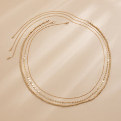 Beautiful 18K gold-plated waist chain set showcasing a luxurious three-strand gold chain for a chic look.