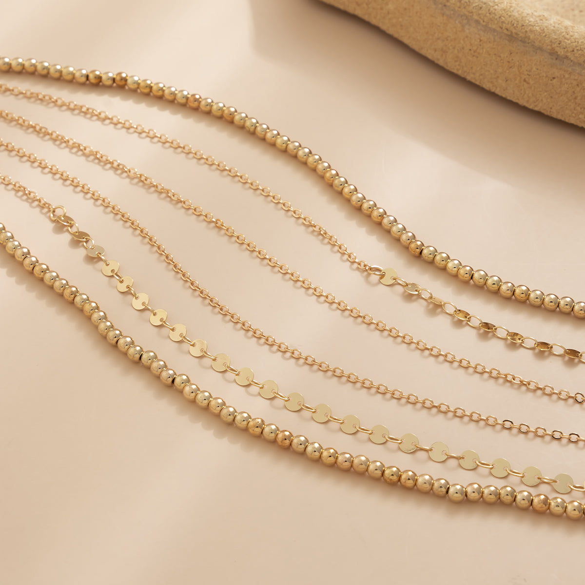 Stylish three-strand gold chain from an 18K gold-plated beaded waist chain set, perfect for any outfit.