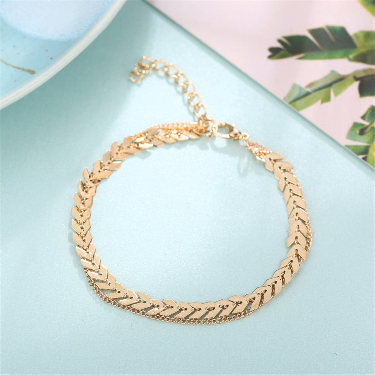 Exquisite gold chain bracelet adorned with a leaf design, crafted in 18K gold plating for a luxurious and stylish look.