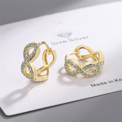 Cubic Zirconia and 18K Gold-Plated Infinity Huggie Earrings, gold huggie earrings, dainty minimalist design, detail close-up