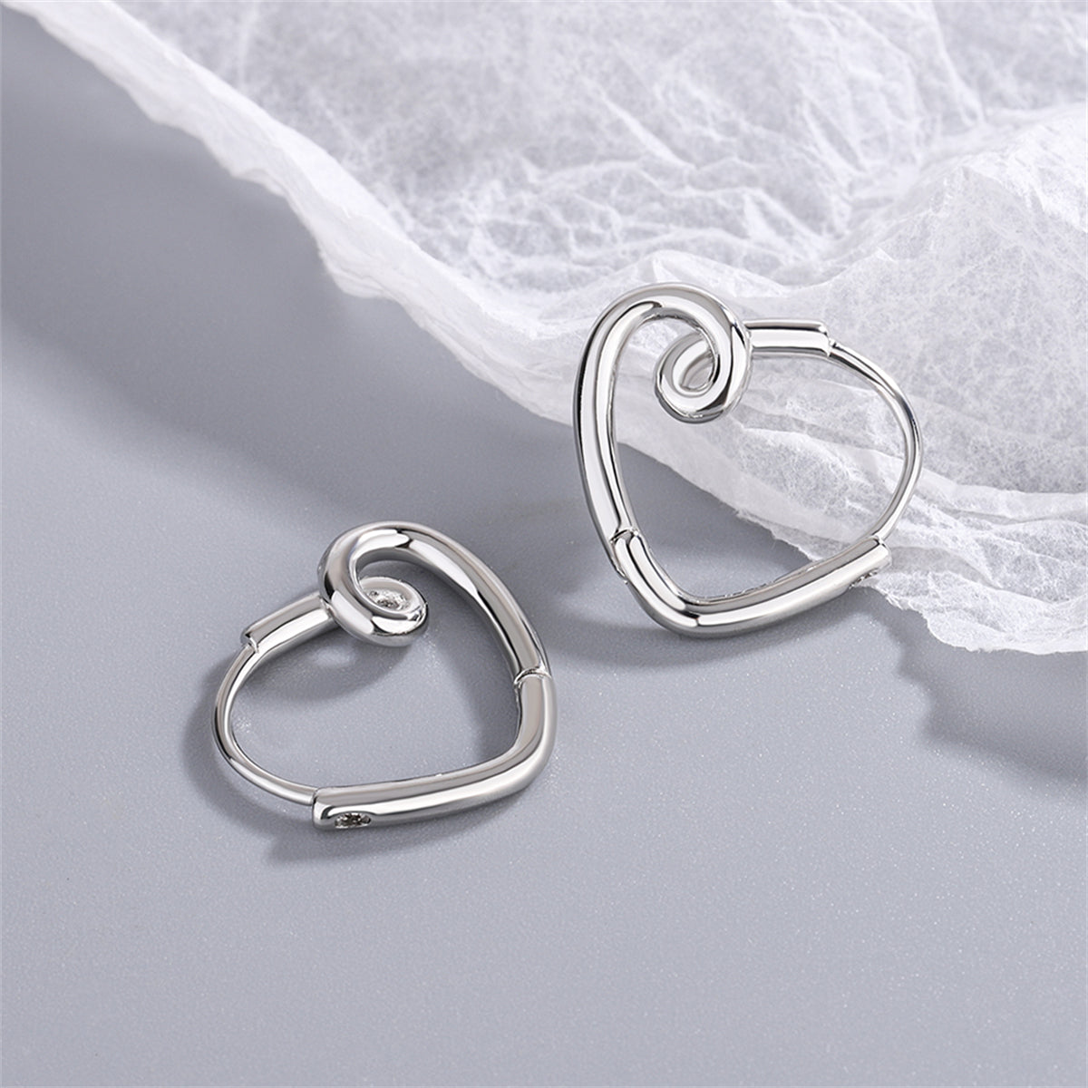 Silver-Plated Heart Huggie Earrings, silver huggie earrings, vintage-inspired design, side view