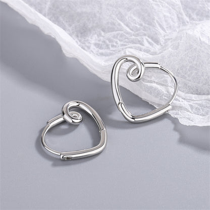 Silver-Plated Heart Huggie Earrings, silver huggie earrings, vintage-inspired design, side view