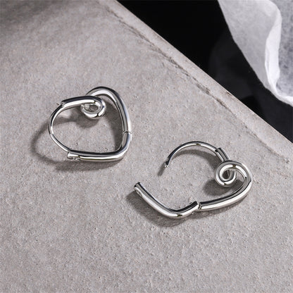Silver-Plated Heart Huggie Earrings, silver huggie earrings, vintage-inspired design, detail close-up