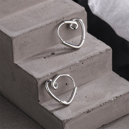 Silver-Plated Heart Huggie Earrings, silver huggie earrings, vintage-inspired design, lifestyle look