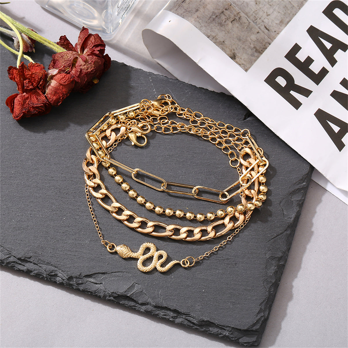 A stunning set of gold chain anklets adorned with a snake charm, showcasing 18K gold-plated craftsmanship.