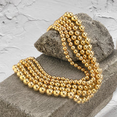 Eye-catching 18K gold-plated necklace showcasing layered golden beads and a fashionable chain, ideal for elevating your style.