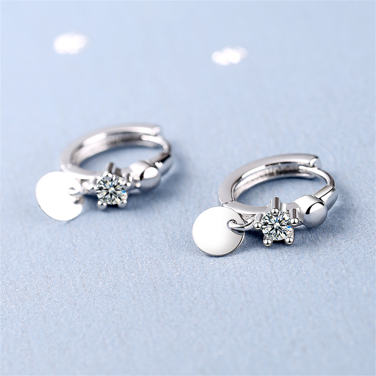 Cubic Zirconia and Silver-Plated Sequin Huggie Earrings, silver huggie earrings, dainty minimalist design, side view