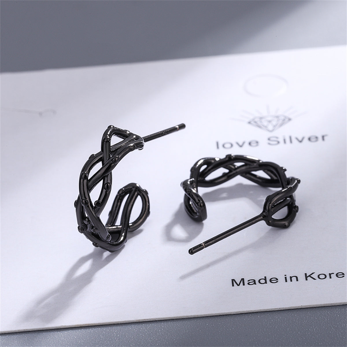 Black Twisted Huggie Earrings, huggie earrings, botanical inspired, detail close-up