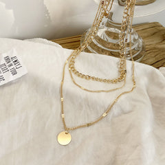 Beautiful 18K gold-plated layered necklace showcasing a yellow disc, perfect for adding a touch of elegance to any outfit.