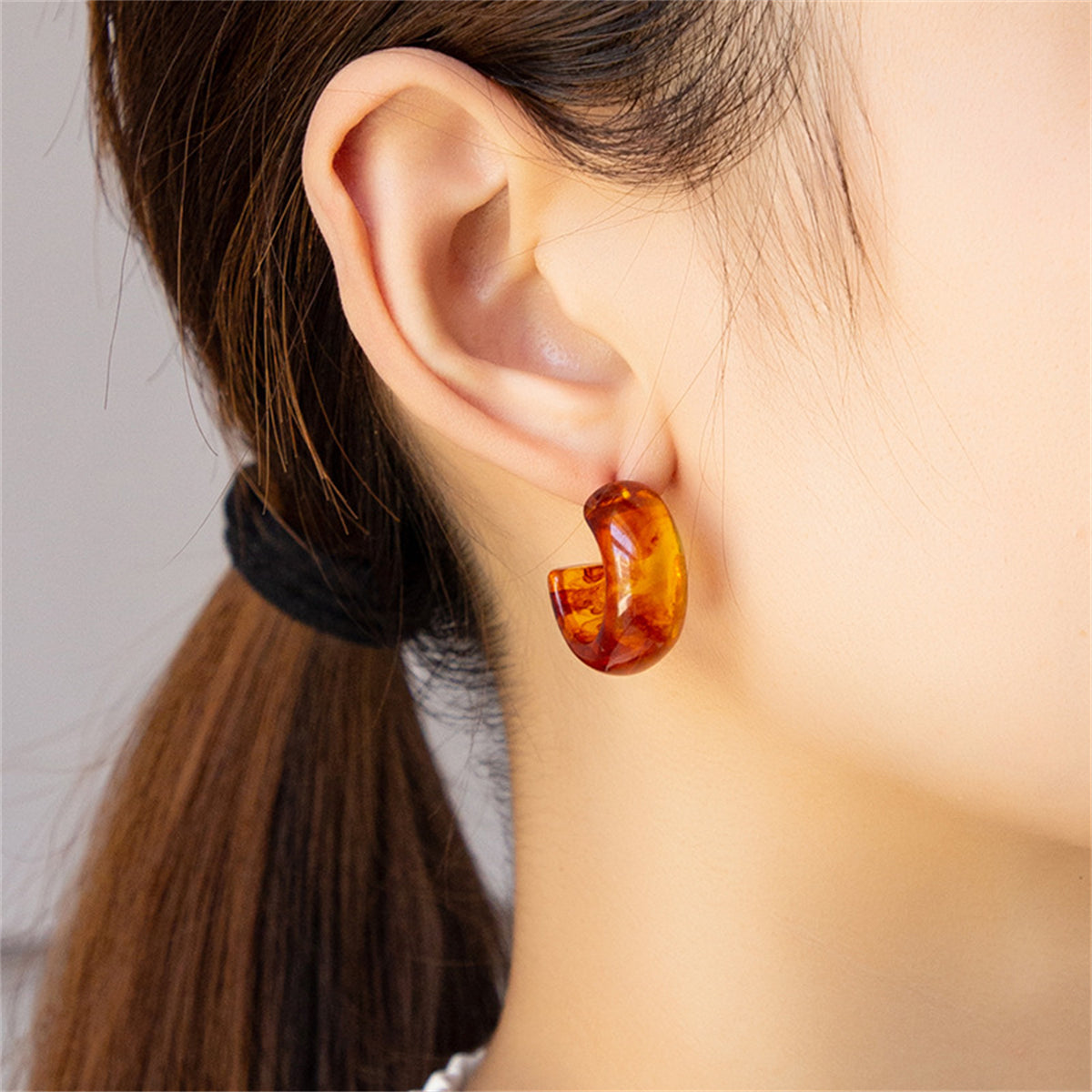 Amber Resin and Silver-Plated Huggie Earrings, silver huggie earrings, dainty minimalist design, front view