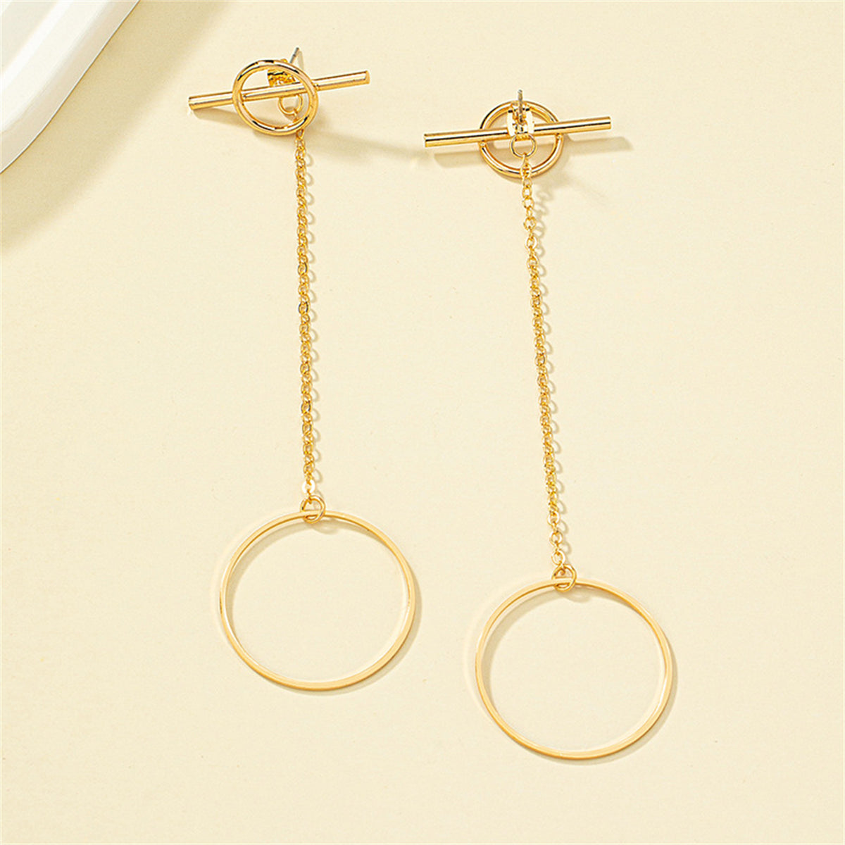 Stylish 18K gold-plated circle bar ear jackets with a delicate chain, perfect for enhancing any outfit with elegance.