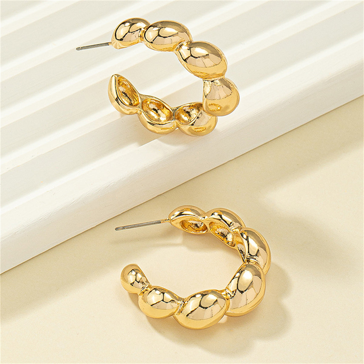 Beautifully crafted 18K gold-plated bead hoop earrings, a must-have accessory for a glamorous look.